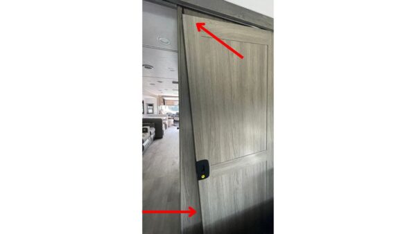 A bedroom door that is completely off the hinges and broken