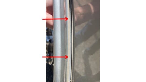 Missing sealant on a wheel well that is pulling away from the side of the RV