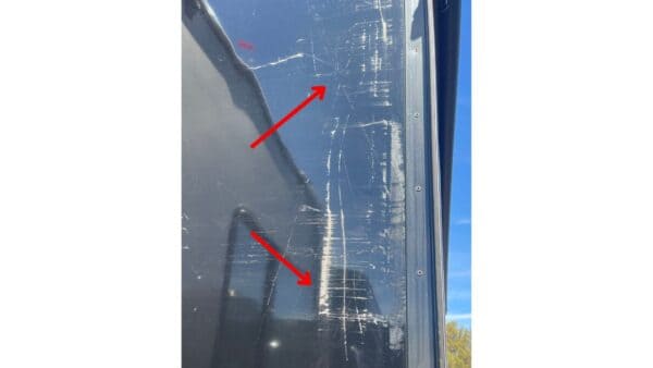 Scraped paint on the sidewalls of a slide room due to poor adjustment at the factory