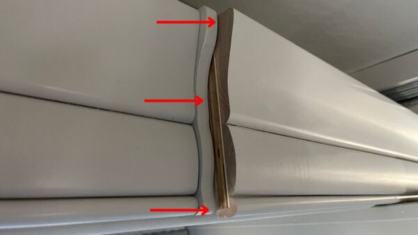 A poorly attached large slide room trim board